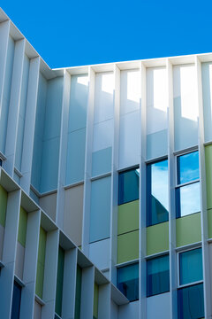 Vibrant architectural details in pastel colors contrast beautifully against the blue sky, creating a stunning visual impact of modern urban design and aesthetics.