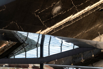 Intriguing reflections and sharp angles in stylish modern architecture create a captivating visual experience, evoking curiosity and admiration for design innovation.