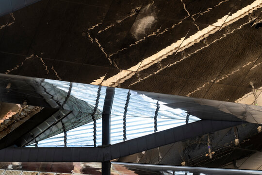 Intriguing reflections and sharp angles in stylish modern architecture create a captivating visual experience, evoking curiosity and admiration for design innovation.