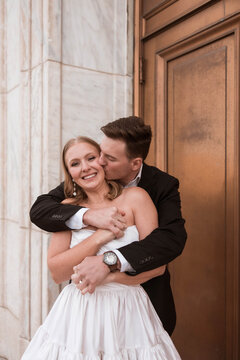 Playful couple hugging during their engagement photos at the DIA