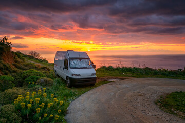 Camper van on a wild spot of Mani Peninsula with sea on the back
