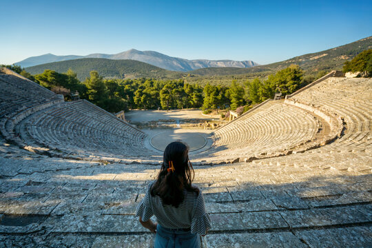 Back view of woman looking at the ancient theatre of Epidaurus