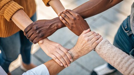 Four Diverse Hands Interlocked Unity, Teamwork, Diversity, High-Angle Composition, Close-up Image Diversity, Inclusion