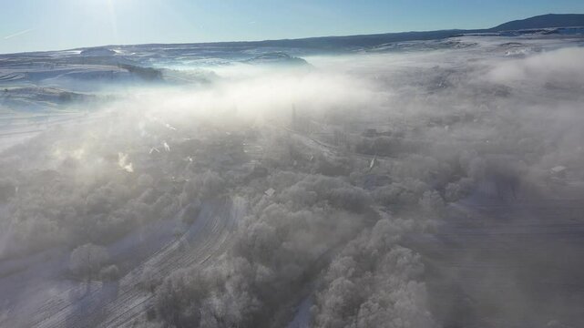 Morning sunrise lights and mist, fog over village houses aerial drone 4k view