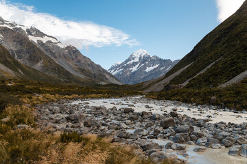 Hiking views of the Hooker Valley track towards Mount Cook (Aoraki) during a calm summer morning with crystal clear sky (South Island, New Zealand)