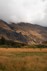 Countryside of New Zealand with a cloud-covered mountain near Diamond Lake in Wanaka (South Island, New Zealand)