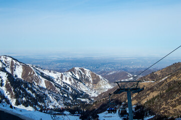 Snowy mountain landscape with ski lift overlooking valley
