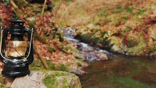 Autumn forest, creek and lanterns, camping