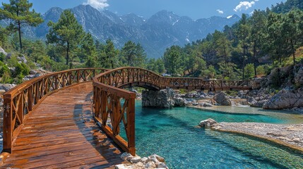 Scenic wooden bridge over a clear river, surrounded by mountains and trees.