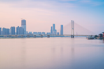 Fototapeta premium The urban skyline, Bayi Bridge, and Ganjiang River scenery of Nanchang City, Jiangxi Province, China on April 1, 2024