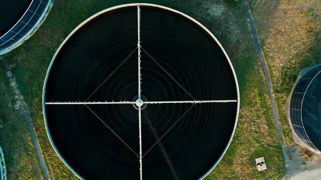 Close up aerial view of circular sedimentation tank at wastewater treatment plant. Top down view of modern sewage treatment plant with circular storage. Sustainable water management