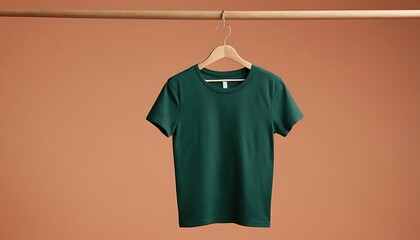 Naklejka premium plain green t shirt on hanger. blank t-shirt mockup,huk mockup of a plain DARK green t-shirt, displayed on a hanger against a clean PEACH background.46321
