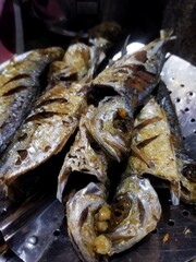 Close up photo of fried fish and traditional chili sauce.