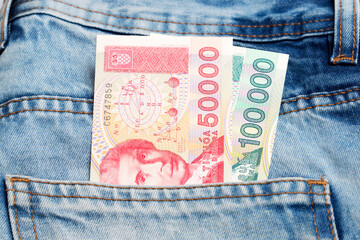Old Croatian dinar in the pocket of blue jeans