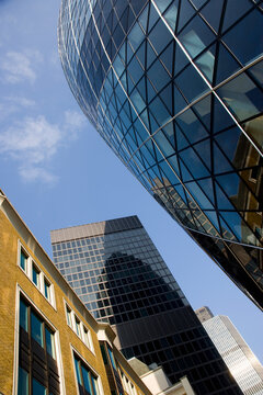This striking image features a blend of modern glass structures alongside traditional architecture, symbolizing the evolving urban landscape and dynamic city life in London UK