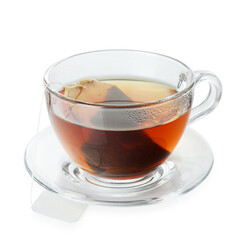 Tea bag in glass cup with hot drink isolated on white