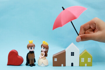 bride and house protected by umbrella - Concept of life, home and auto insurance