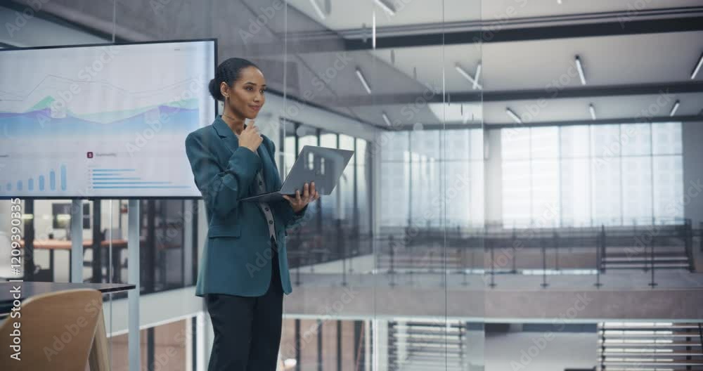 Poster portrait of a beautiful black manager reviewing sales reports on laptop computer in an office. young