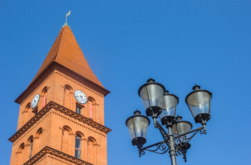 Street light in front of the church tower in Torun, Poland