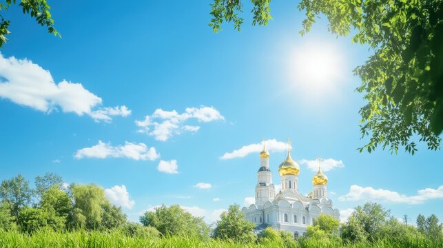 Majestic cathedral with golden domes in lush greenery under clear blue sky