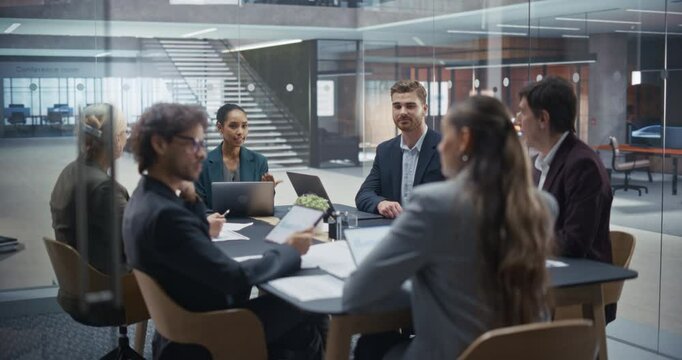 Company Executives Sharing Ideas and Debating Strategies in a Meeting Room. Male and Female Colleagues Discuss Market Trends, Analyze Competitive Landscapes and Develop Innovative Business Plans