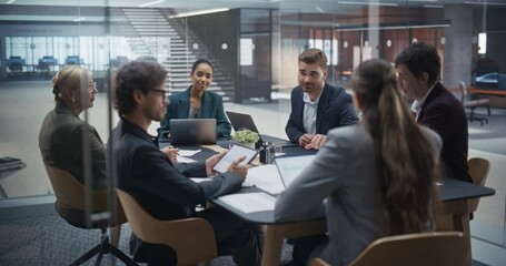 Diverse Group of Professionals Engaging in a Productive Meeting in a Glass-Walled Conference Room. Managers Address Challenges, Look at Data, Explore Solutions and Make Critical Decisions