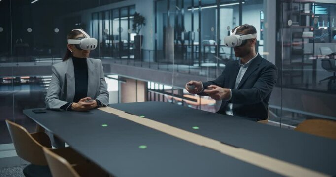 Business Partners Conduct a Virtual Negotiation in a Conference Room. Male and Female Wearing VR Sets as They Review and Discuss Pricing Strategies and Finalize the Deal in an Immersive 3D Environment