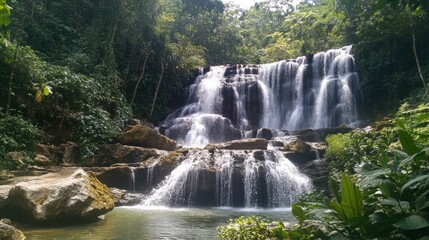 Fototapeta premium Cascading Waterfall in Lush Tropical Rainforest