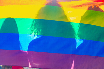 People holding rainbow flag celebrating gay pride