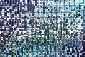 Decorative wall with ornament of shiny mirror blue squares.