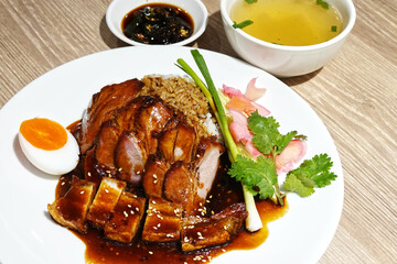 Red pork and crispy pork rice, egg and vegetable with soup and spicy sauce.