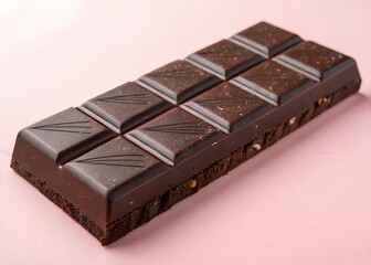 Delicious dark chocolate bar on pink background