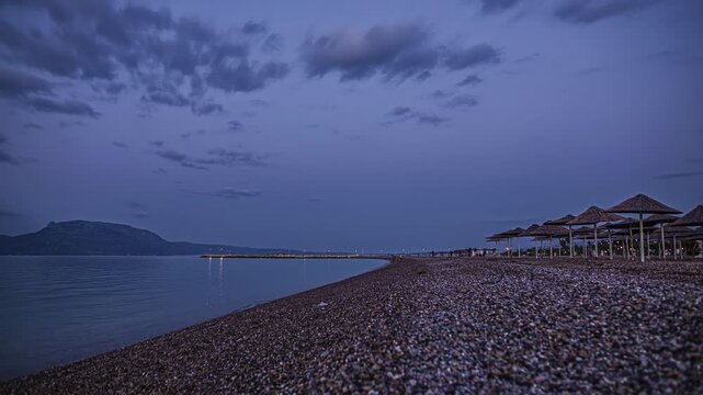 Timelapse view of seashore during dusk with clouds moving.