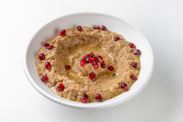 Dish of Lebanese baba ganoush isolated on white background , typical dish of Lebanese cuisine eggplant and vegetable sauce