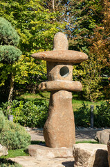 apanese garden in Galitskrgo park in Krasnodar Japanese garden lantern Yukimi-gata or “snow lantern” is squat lantern with wide roof. Lantern against backdrop of greenery of garden.