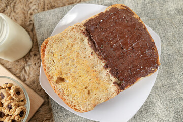 Bread with chocolate spread filling, milk and snack for breakfast	
