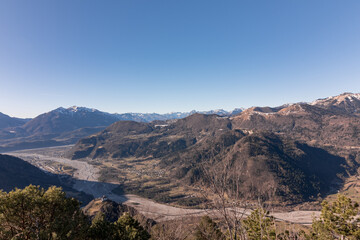 Panorama of the Carnic mountains from the top of Mount Giaideit, Friulian Alps. Sunny day and view of the Pieve di San Floriano.