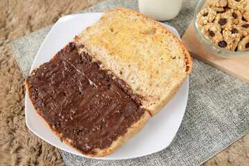 Bread with chocolate spread filling, milk and snack for breakfast	
