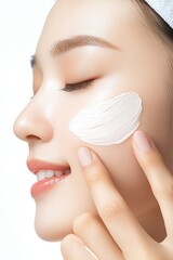 A woman applying a facial mask for skincare, showcasing softness and beauty in her routine.
