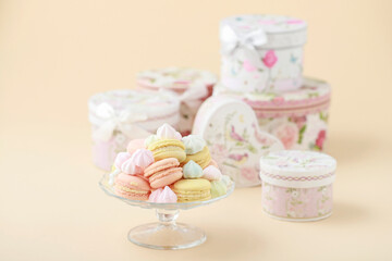 A crystal platter full of French macaroons and miniature meringues in pastel colors.