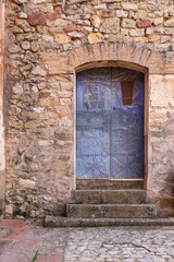 Wrought iron door with stone staircase in Albarracin town