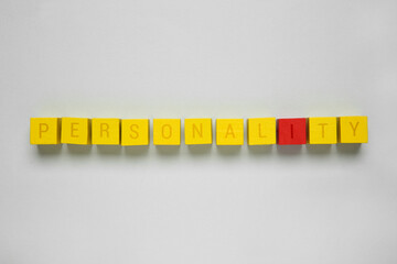Word Personality made of cubes with letters on light grey background, top view