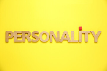 Word Personality made of wooden letters on yellow background, top view