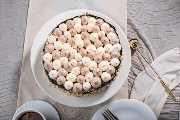 Kyiv cake with nuts, buttercream on a white cake plate, yellow runner, white dishes, espresso coffee, gold cutlery, Ukrainian desserts, nut cake, birthday cake