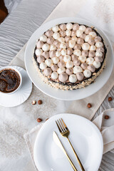 Kyiv cake with nuts, buttercream on a white cake plate, yellow runner, white dishes, espresso coffee, gold cutlery, Ukrainian desserts, nut cake, birthday cake