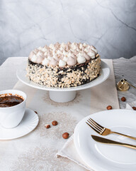 Kyiv cake with nuts, buttercream on a white cake plate, yellow runner, white dishes, espresso coffee, gold cutlery, Ukrainian desserts, nut cake, birthday cake