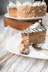 Esterhazy cake in a cut, traditional Hungarian, German cake with almonds and condensed milk, nut cake, whipped cream, coffee on a light background, flatlay, still life, food photo dessert