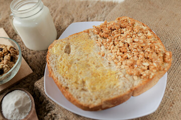 Bread with peanut and butter spread on a table for breakfast	
