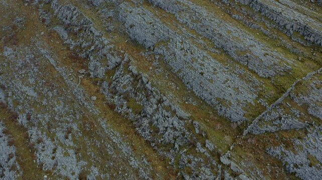 Aerial top-down dolly exploring rugged Burren hills and revealing stunning views. County Clare