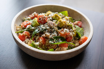 Close-up of a vibrant and nutritious salad made with quinoa, avocado, mixed seeds, and cheese, packed with protein and healthy fats for a wholesome meal